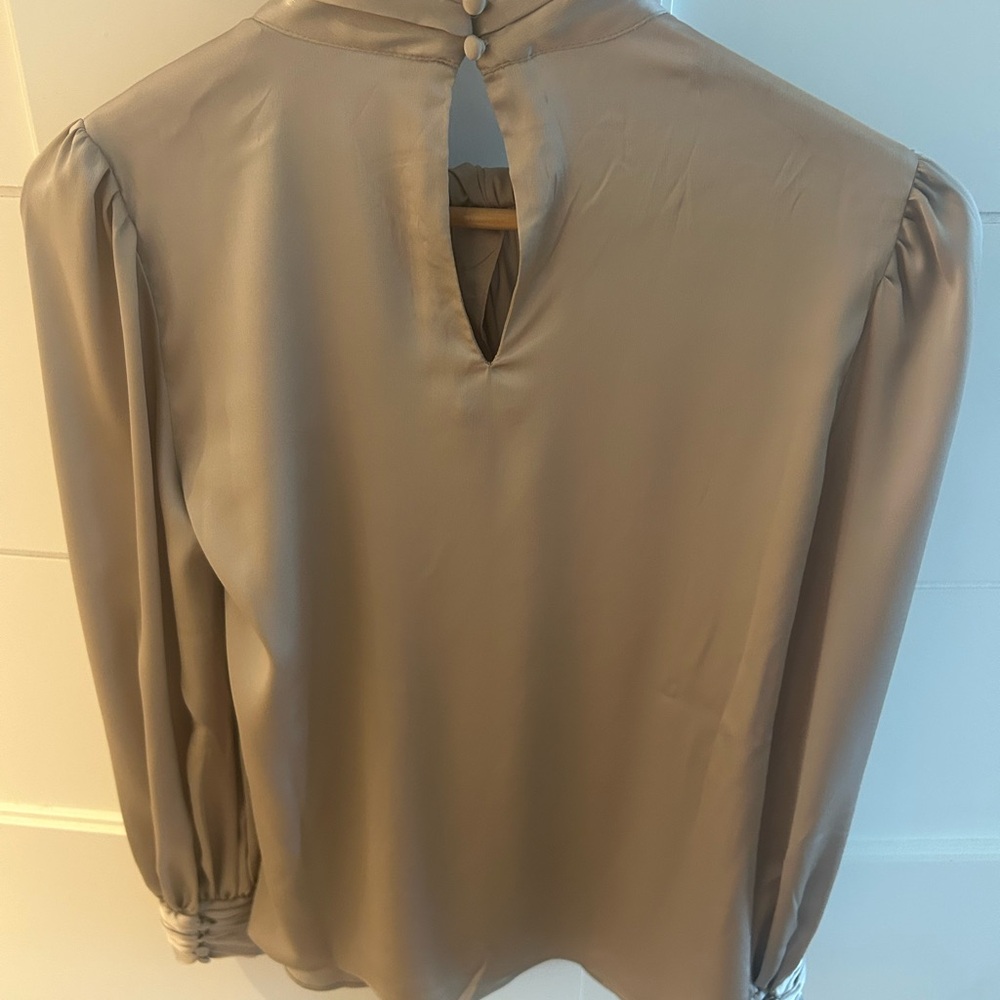 This satin blouse has a twisted neckline keyholes and blouson sleeves for flair - Picture 4 of 7